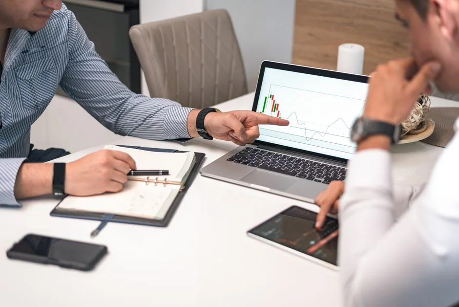 A clean and modern desk setup with a lightbox displaying #TREND and a computer monitor showing a social wall solution.